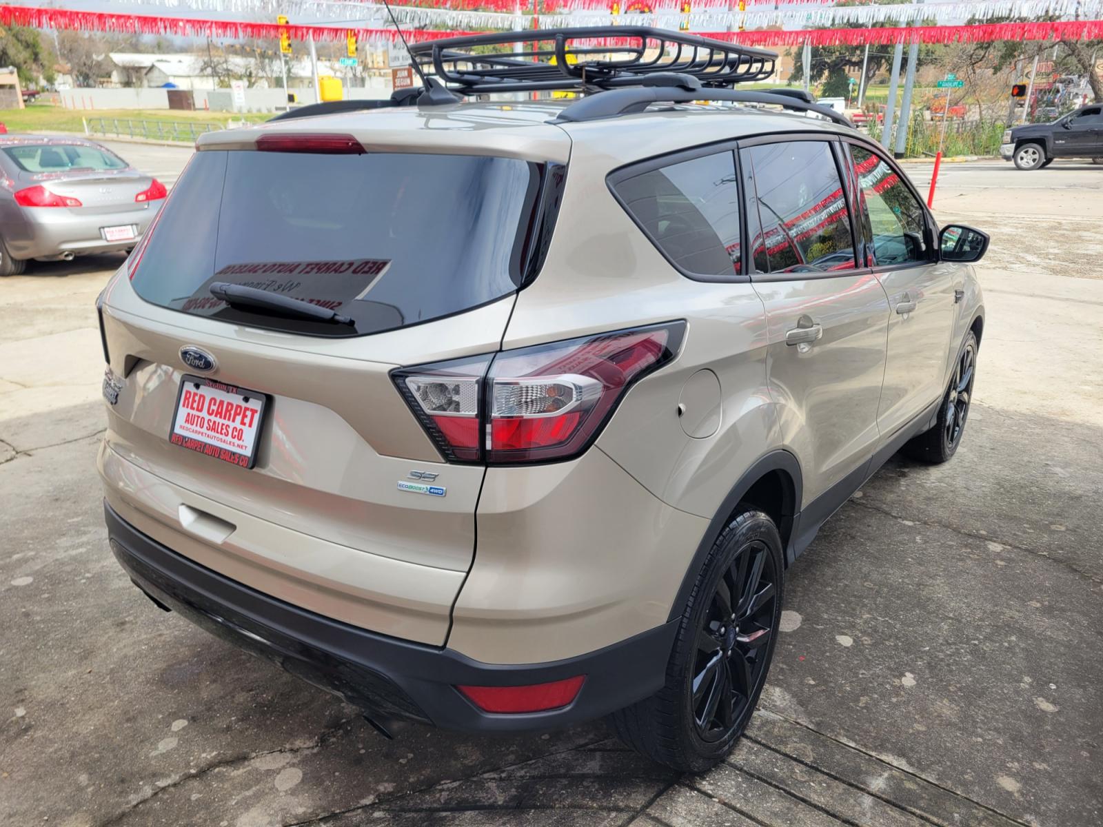 2018 Gold Ford Escape (1FMCU9GD5JU) with an 1.5L I4 F DOHC 16V engine, Automatic transmission, located at 503 West Court, Seguin, TX, 78155, (830) 379-3373, 29.568621, -97.969803 - 2018 Ford Escape SE 4WD with a 1.5L I4 F DOHC 16V, Automatic, Tilt, Cruise, AM/FM/CD Touchscreen Stereo, Power Windows, Locks, Seat and Side Mirrors, Bluetooth, Navigation, Automatic Headlights, Dual Climate Control, Rear A/C, Heated Seats, Tinted Windows, Luggage Rack, Backup Camera, Bumper Sensors - Photo #2